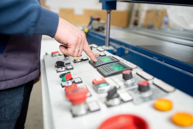 hand worker on control panel