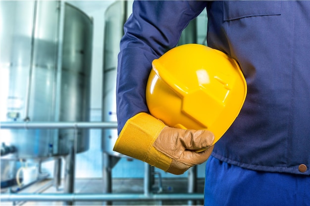 hand of worker with yellow hard-hat,natural light