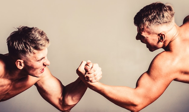 Hand wrestling, compete. Hands or arms of man. Muscular hand. Two men arm wrestling. Rivalry, closeup of male arm wrestling. Men measuring forces, arms.