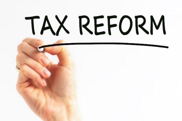 Hand writing inscription TAX REFORM with black color marker