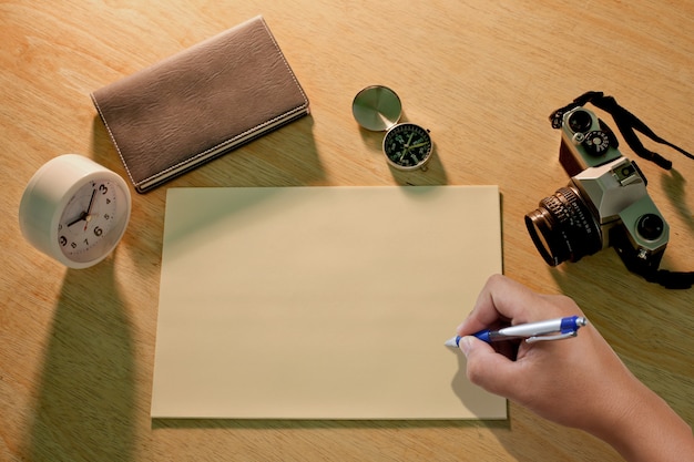 Photo hand writing something on the paper sheet.