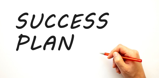 Hand writing success plan with pen isolated on white background