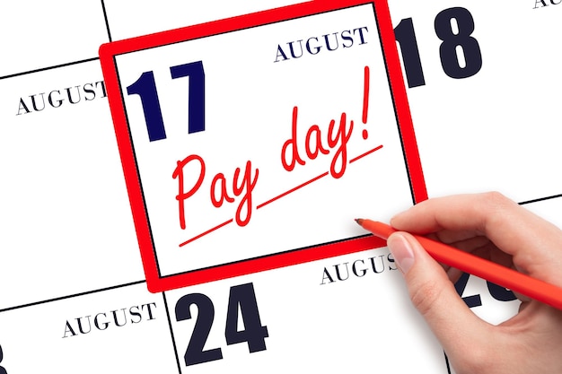 Photo hand writing text pay date on calendar date august 17 and underline it payment due date