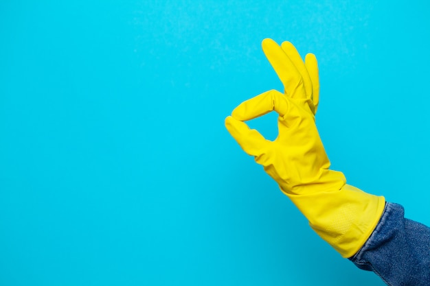 Hand in a yellow glove for cleaning