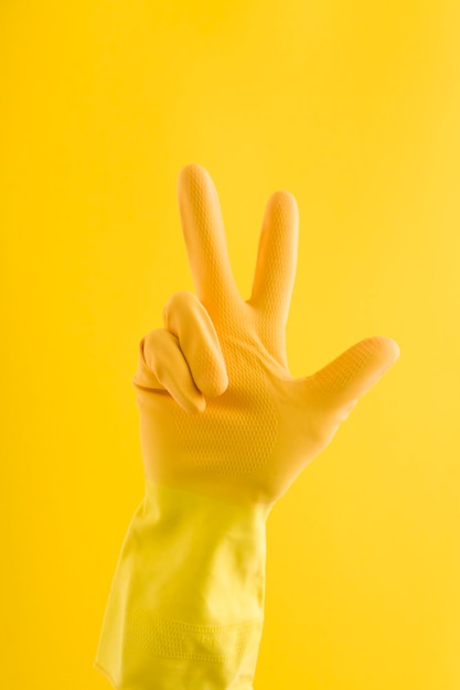 Hand in a yellow rubber cleaning glove