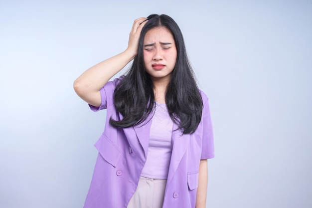 Photo hand of young asian woman on head suffering from headache desperate and stressed