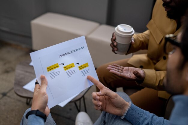 Hand of young confident businessman pointing at business document