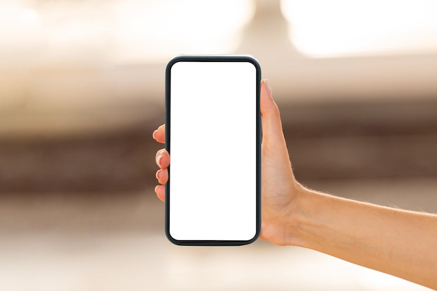 Hand of young european lady show smartphone with empty screen