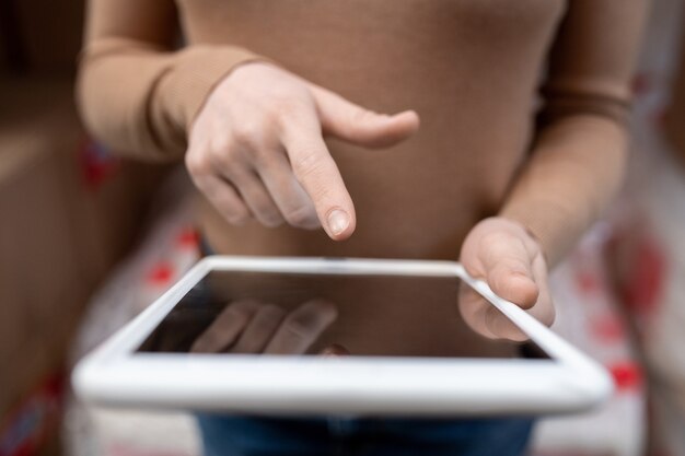 Photo hand of young female warehouse worker over tablet display