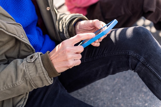 Hand of a young person using mobile phone