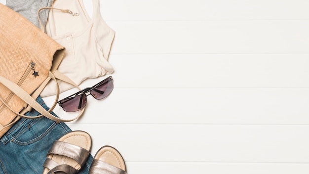 Фото Сумочка возле солнцезащитных очков с одеждой и обувью