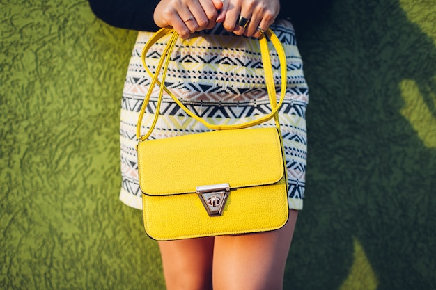 Handbag. Young woman holding stylish yellow bag. 