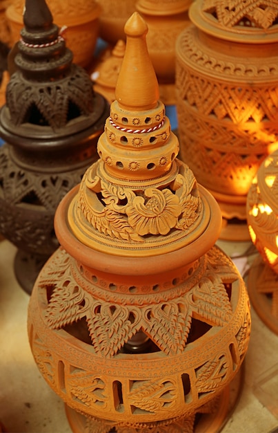 Handcarving intricate patterns of famous Koh Kret pottery Koh Kret Island Near Bangkok Thailand