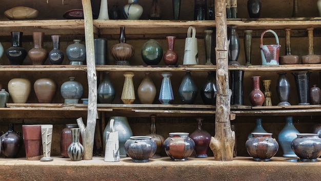 Handcraft ceramic kitchenwares molded arranged on shelve