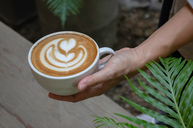 Handcraft of hot milk coffee cup, stock photo