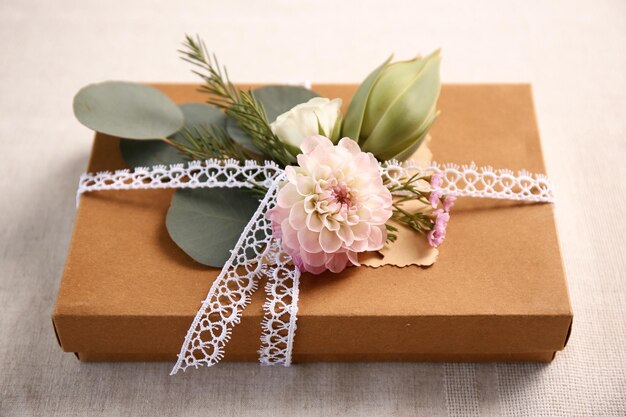 Handcrafted gift box with flowers on table