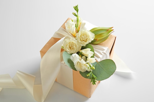 Handcrafted gift box with flowers on white background