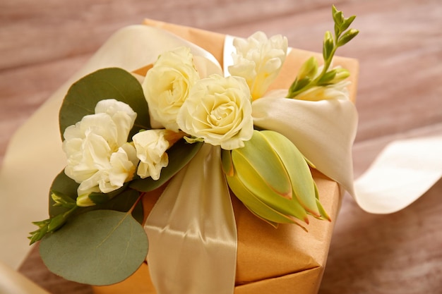 Handcrafted gift box with flowers on wooden table