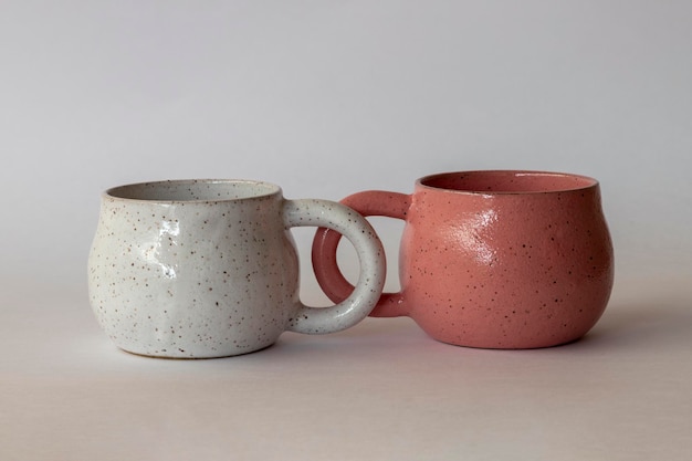 Handcrafted white ceramic cups and rose