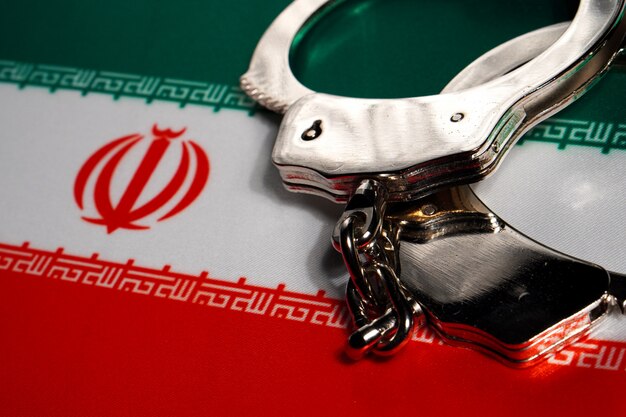 Handcuff on the flag of Iran.