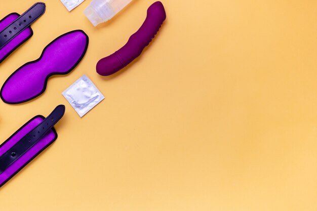 Photo handcuffs and sleeping mask on a yellow background