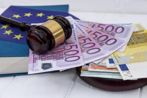 Handcuffs with euro banknotes and judge's gavel