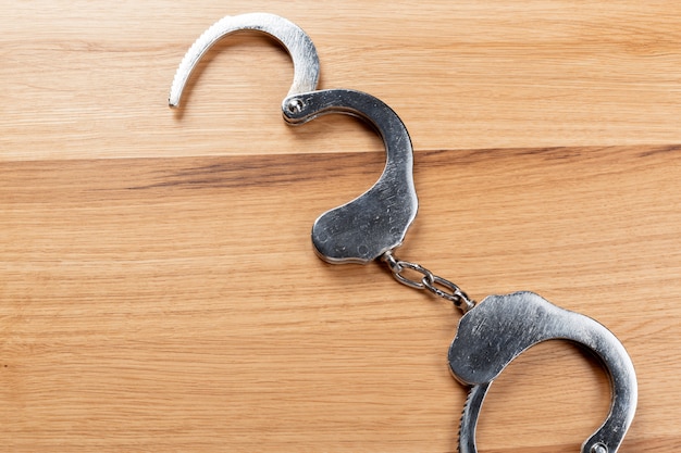 Handcuffs on a wooden table