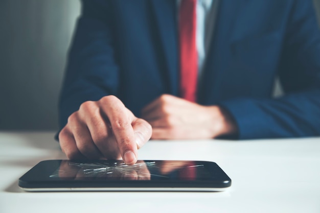 Handen met een mobiele telefoon met een gebroken scherm