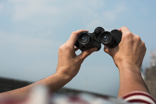 Handen met verrekijker reizen ontspannen