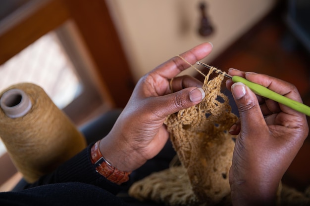 Handen van een vrouw die gehaakte huisactiviteiten doet Handgemaakte stof