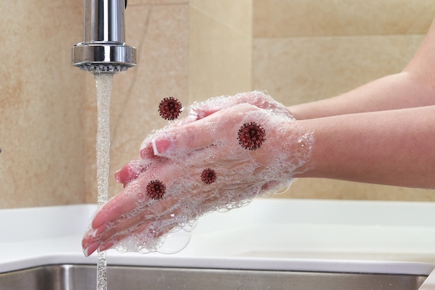 Handen wassen met virussen in de buurt. vrouw zeep spoelen met stromend water bij gootsteen, Coronavirus 2019-ncov preventie handhygiëne.