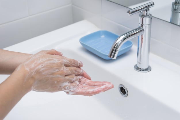 Handen wassen met zeep onder stromend water