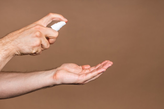 Handenwassen. Man handen met behulp van washand sanitizer gel pomp dispenser voor bescherming coronavirus en bacteriën, gezondheidszorg concept. Detailopname.