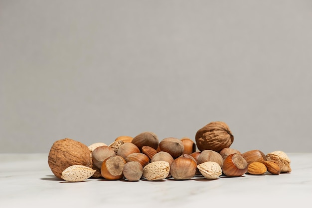 A handful of different nuts on a gray background