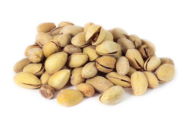 Handful of fried pistachios isolated on white surface