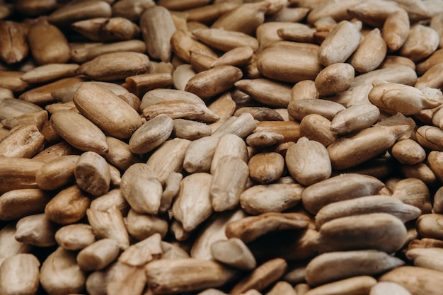 a handful of peeled sunflower seeds on a white table