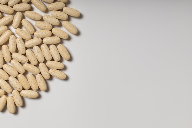 Handful of pills side view on white background