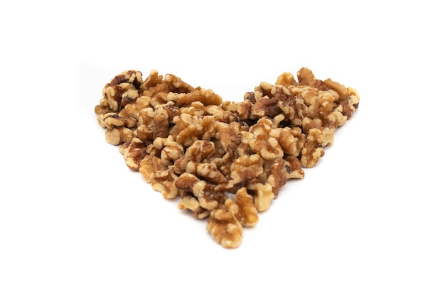 A handful of walnuts in the shape of a heart Isolated on white background