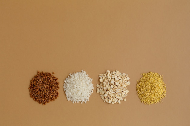 Handfuls of various cereals Rice and oatmeal buckwheat and millet