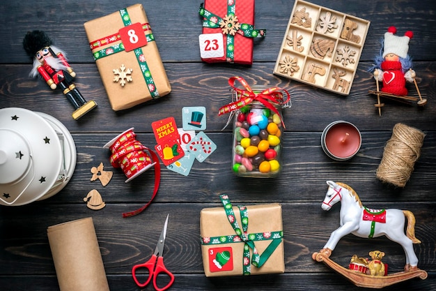 Handgemaakte verpakte roodgroene geschenkdozen versierd met linten, sneeuwvlokken en cijfers op tafel