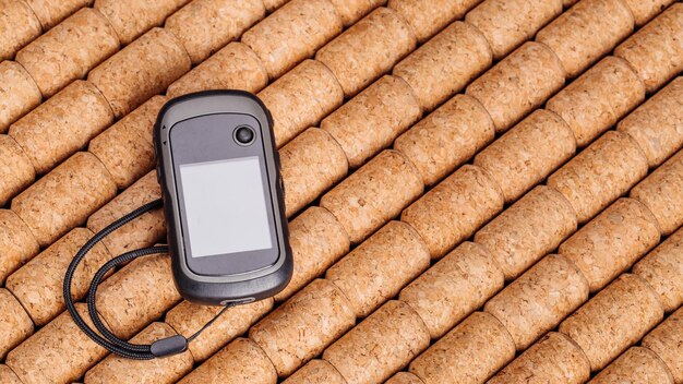 Handheld satnav gps on the cork wooden table background