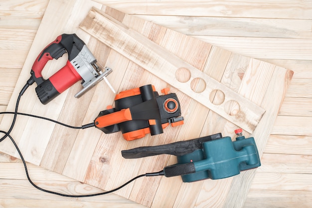 Handheld woodworking power tools lies on a table