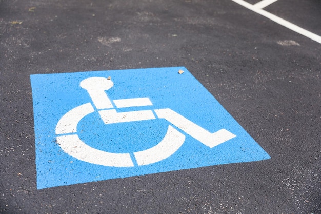 A handicap sign on the ground is painted on the ground.