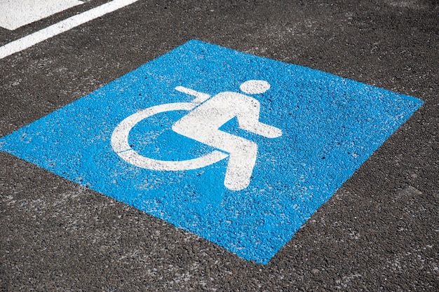 Photo handicapped symbol painted on asphalt. traffic sign