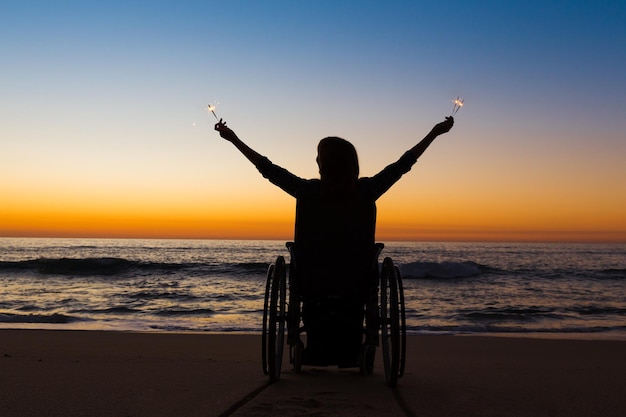 Handicapped woman holding fire sparklers