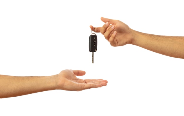 Photo handing over the car key hands isolated on white background clipping path