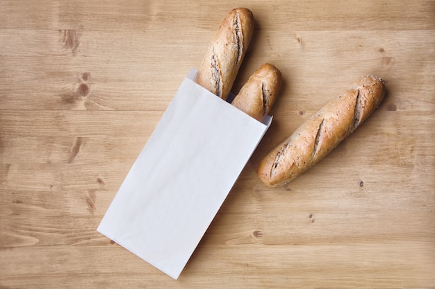 Photo handmade bread in a paper bag on the table