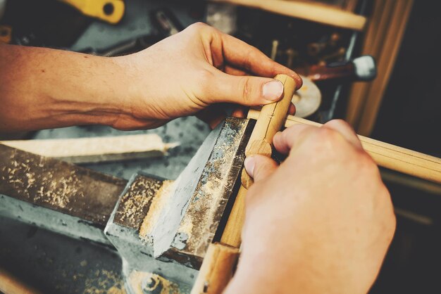 Handmade in a carpenter's workshop Male hands close up while working