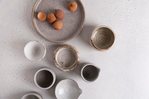 Handmade ceramic tableware, empty craft ceramic on a light background. Clay plates and cups