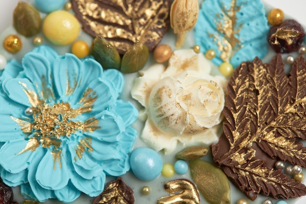 Handmade chocolate bar decorated with flowers and leaves Closeup